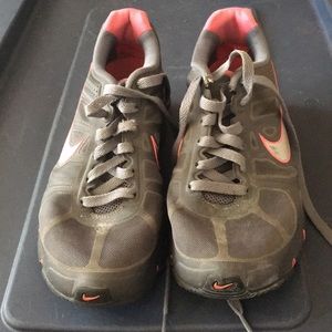 Gray and pink Nike tennis shoes